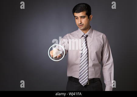 Businessman pressing startplay button on virtual screen Stock Photo