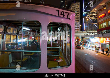 HONG KONG, CHINA - CIRCA JANUARY, 2019: close up shot of a typical HKT double-decker tram in Hong Kong at night. Stock Photo
