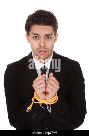 Businessman with hands tied in network cable. Isolated on white Stock Photo