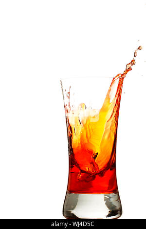 one ice cube falls in one glas with red liquid Stock Photo