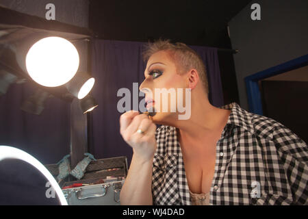 Serious cross dressing person in backstage fixing bra Stock Photo - Alamy