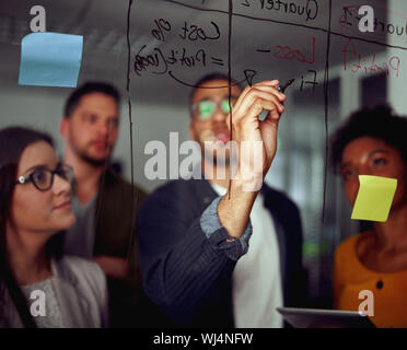 Group of multicultural creative employees collaborating on creating presentation Stock Photo