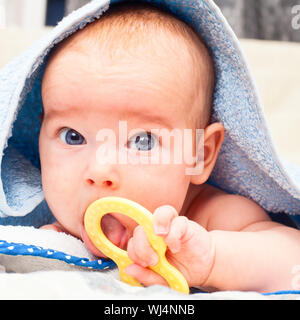 Little baby girl playing with teething toy Stock Photo