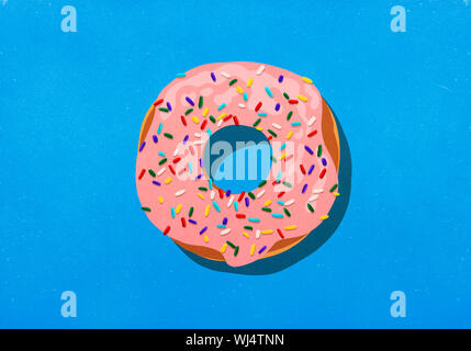Pink donut with sprinkles on blue background Stock Photo