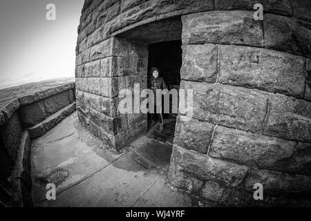 A child exploring inside Stoodley Pike, on the Pennine way, Calderdale, West Yorkshire, England. Stock Photo