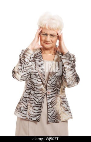 An old elegant lady is having a headache. Isolated on white. Stock Photo