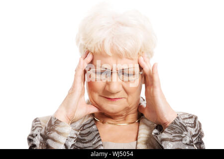 An old elegant lady is having a headache. Isolated on white. Stock Photo