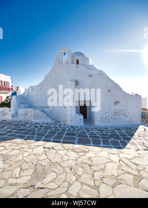 Shabby white walls of aged Paraportiani Orthodox Church on street of town of Mykonos Island in Greece Stock Photo