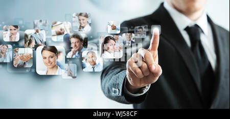 Businessman finger touches virtual buttons Stock Photo