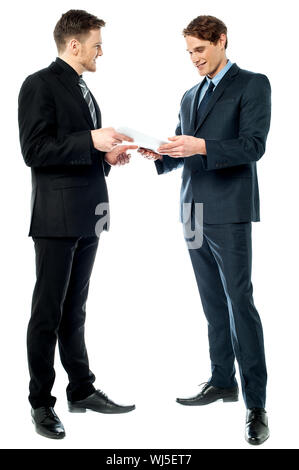 Business executives discussing the reports Stock Photo