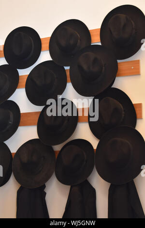 Black Fedora Hats Hanging on  Wall Stock Photo