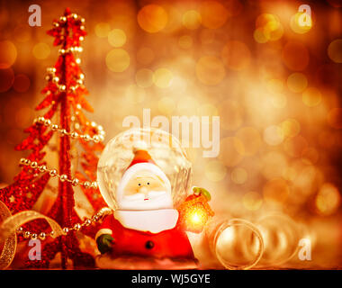 Red Christmas background with cute snow globe Santa Claus border over blur bokeh lights, magic of Christmas holidays, xmas greeting card Stock Photo
