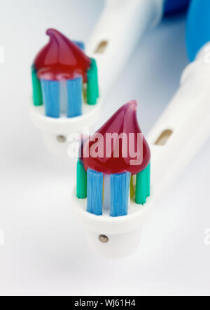 Two Electric Toothbrushes with Herbal Toothpaste closeup Stock Photo