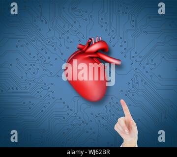 Composite image of model pointing at heart on blue circuit board background Stock Photo