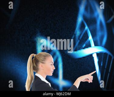 Composite image of blonde businesswoman pointing somewhere on black background with glowing blue dna spiral Stock Photo