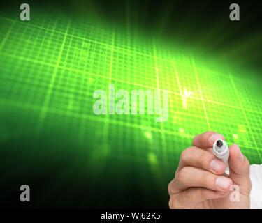 Composite image of businessman writing on camera with a marker pen on black background with green glowing raster Stock Photo