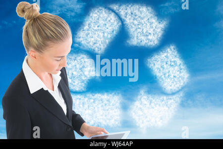 Composite image of blonde businesswoman holding tablet Stock Photo