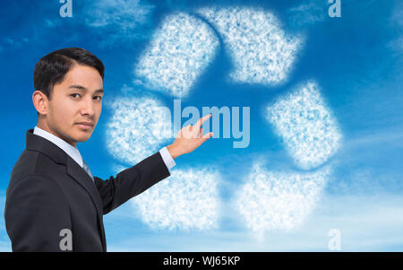 Composite image of stern asian businessman pointing Stock Photo