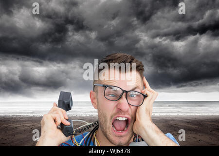 Composite image of portrait of frustrated computer engineer screaming while on call in front of open cpu over white background Stock Photo