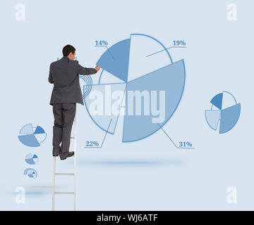Composite image of businessman standing on ladder writing Stock Photo