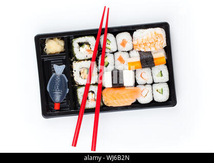 Delicious sushi rolls on white plate with chopsticks Stock Photo