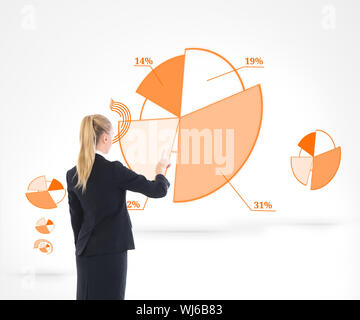 Composite image of blonde businesswoman pointing somewhere Stock Photo