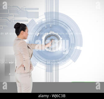 Composite image of unsmiling asian businesswoman pointing Stock Photo