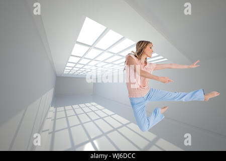 Composite image of woman doing dance pose Stock Photo
