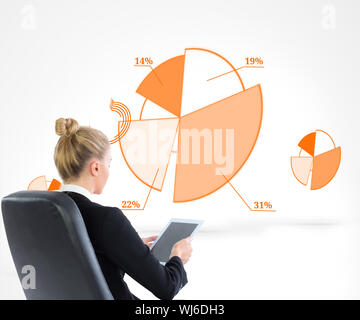 Composite image of blonde businesswoman sitting on swivel chair with tablet Stock Photo