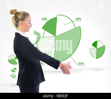 Composite image of blonde businesswoman holding piggy bank Stock Photo