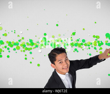 Composite image of smiling asian businessman pointing Stock Photo