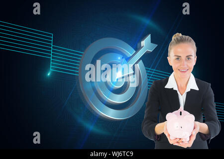 Composite image of blonde businesswoman holding pink piggy bank Stock Photo