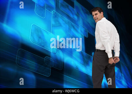Composite image of rear view of young businessman wearing handcuffs Stock Photo