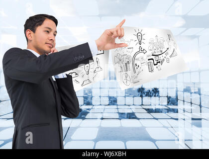 Composite image of thoughtful asian businessman pointing Stock Photo