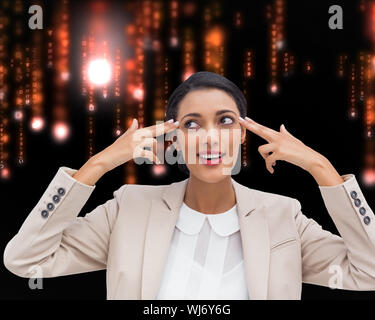 Composite image of confident young businesswoman pointing her head with her fingers Stock Photo