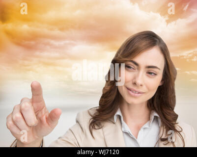 Composite image of businesswoman touching invisible screen against white background Stock Photo