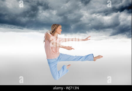 Composite image of woman doing dance pose Stock Photo