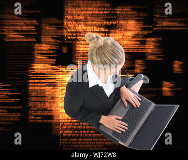Composite image of blonde businesswoman using laptop Stock Photo