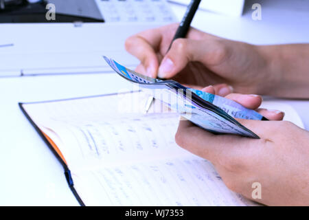Tenge in the hands of an accountant cashier at a company in Kazakhstan.