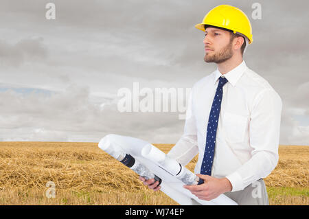 Composite image of thoughtful young architect posing Stock Photo