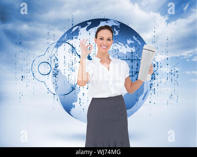 Composite image of stylish businesswoman making gesture while holding newspaper Stock Photo