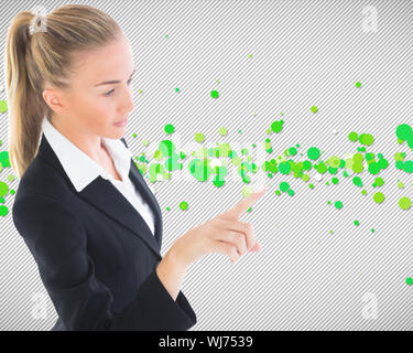 Composite image of blonde businesswoman pointing somewhere Stock Photo