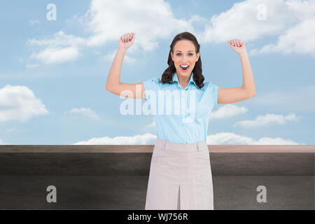 Composite image of victorious stylish businesswoman posing Stock Photo