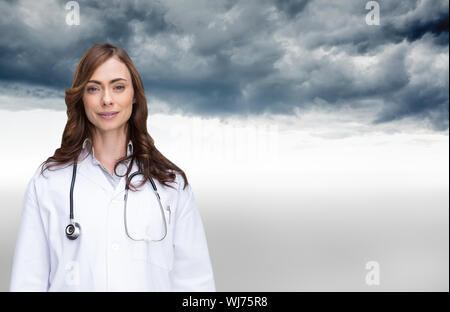 Composite image of happy brunette doctor looking at camera Stock Photo