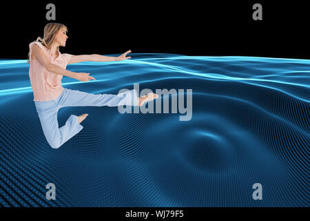 Composite image of woman doing dance pose Stock Photo