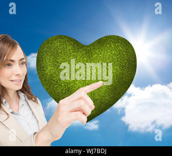 Composite image of businesswoman pressing an invisible key against a white background Stock Photo
