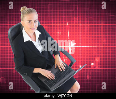 Composite image of blonde businesswoman sitting on swivel chair with laptop Stock Photo