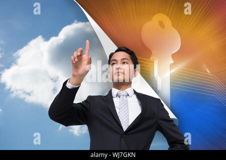 Composite image of unsmiling asian businessman pointing Stock Photo