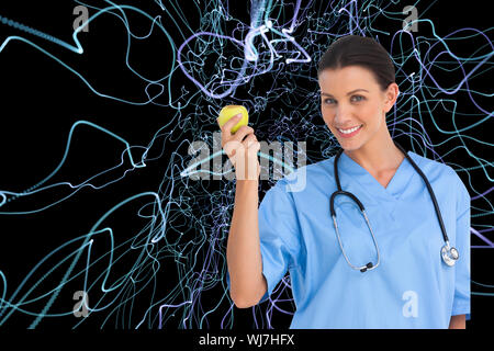 Composite image of happy surgeon holding an apple and smiling at camera Stock Photo