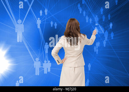 Composite image of businesswoman standing back to camera writing with marker Stock Photo
